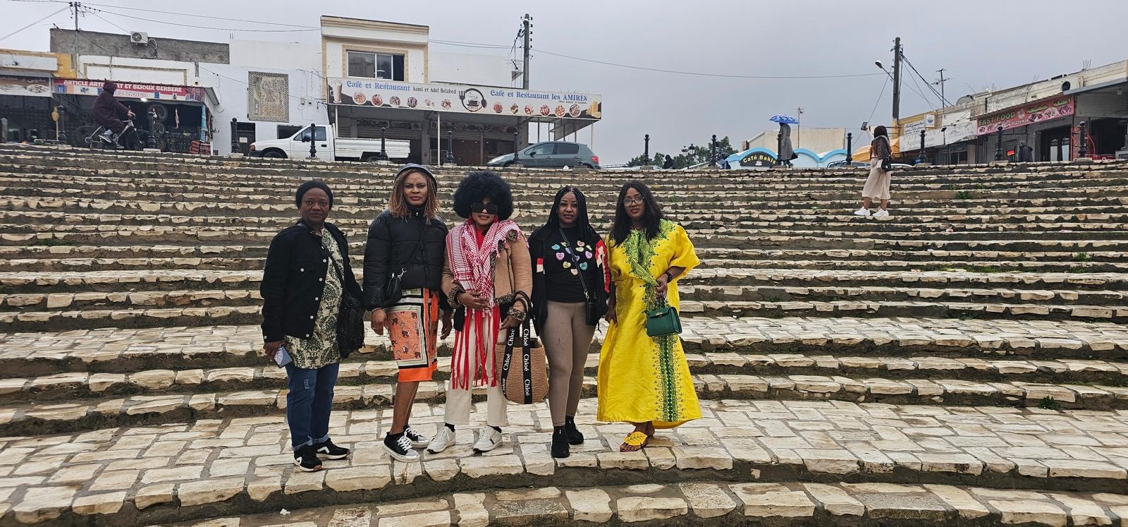 Group of friends on the stone steps of a Moroccan town square